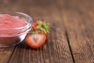 Fresh made Strawberry powder on a vintage background as detailed close-up shot