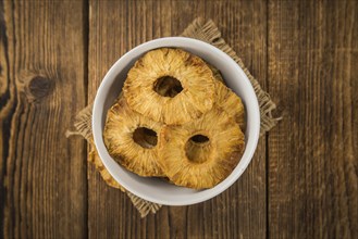 Dried Pineapple Rings on a vintage background as detailed close-up shot, selective focus