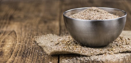 Wheat Bran on an old wooden table (selective focus)