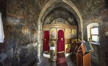 Interior with antique frescoes in the historic small single-nave church Panagia Throniotissa Naos