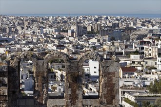 View over the window arch of the Odeon of Herodes Atticus to Athens and the Aegean Sea, Greece,