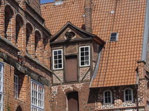 Detail of historic brick architecture with windows and doors in gable arrangement, lüneburg,