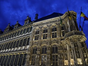 Impressive historic building at night with illuminated sky and flags, Ghent, Belgium, Europe