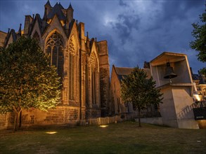 Gothic church and garden in night light, illuminated architecture, Ghent, Belgium, Europe