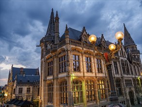 Historic building with striking lighting under a cloudy evening sky, Ghent, Belgium, Europe