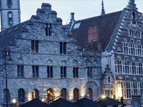 Historic building with stone façade illuminated at dusk, Ghent, Belgium, Europe