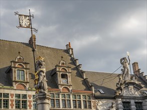 Historic town square with impressive architecture and statues under a cloudy sky, Ghent, Belgium,