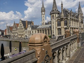 A picturesque view over a bridge in the city, along a canal with historic buildings, Ghent,