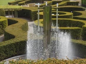 Formal garden with modern fountain and artfully trimmed hedges, Newcastle, England, Great Britain