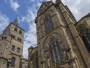 View of a gothic church with high towers and ornate ornaments under a blue sky, trier, germany
