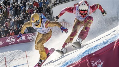 Two snowboarders compete in a downhill race with a crowd watching, capturing the excitement and