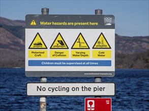 Warning sign at the beach, village Luss, Lake Lomond, potential water hazards, Scotland, UK