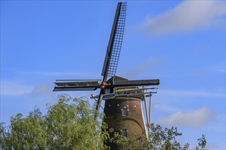 Close-up of a large windmill with blue sky and a few clouds in the background, bredevoort,