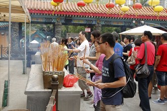 People praying in a temple, Hong Kong, Asia