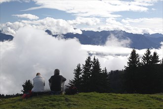 Hikers resting above the clouds on the Horner Group