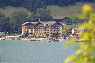 Hotel on the shore of a lake surrounded by green nature and summer atmosphere, Achernsee, Austria,