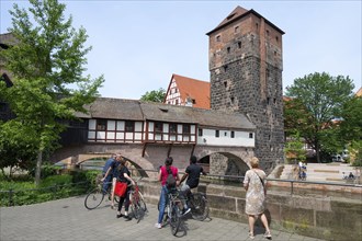 Tourists in front of the Henkersteg with water tower on the Pegnitz Nuremberg, Middle Franconia,