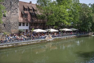 Well-attended garden pub on the Pegnitz, Nuremberg, Middle Franconia, Bavaria, Germany, Europe