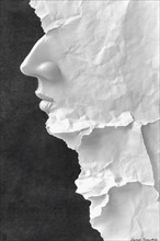 Artistic face profile formed from crumpled paper on a dark background, creating a textured,