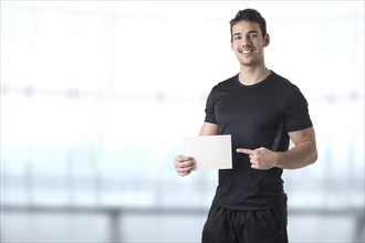 Male Personal Trainer Holding an Empty Card