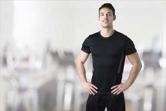 Personal Trainer With Hands on Waist in a Gym