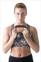 Fit woman working out with a kettlebel and similingl, isolated in white