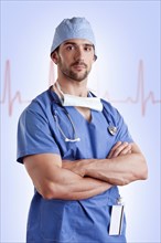 Young male surgeon with scrubs and a stethoscope, with a EKG graph behind him