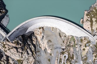 Aerial view of reservoir dam Barrage du Vieux Emosson and mountain hut Cabane Vieux Emosson,