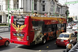 Mexico City, Mexico, Central America, Red Turibus on a city tour drives past old buildings and