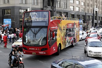Mexico City, Mexico, Central America, Red double-decker bus with tourists drives through the city