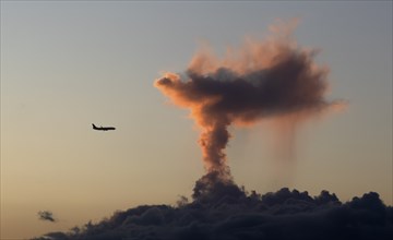 Aeroplane, jet, approaching Humberto Delgado Airport LPPT, in front of clouds in dramatic light in