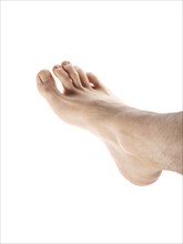 Right male foot isolated towards white background, with hair on leg