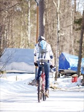 Person riding a bike, on snow at winter