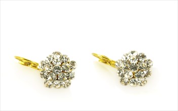 Diamond earrings on yellow gold, isolated towards white background