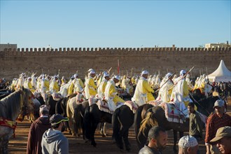 Meknes, Morocco, March 31, 2018: Uniformed tribal group with rifles mounted on horses waiting for