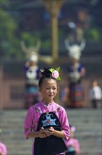 Xijiang, China, September 15, 2007: An Miao ethnic minority girl dressed in pink and black
