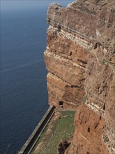 An impressively steep, rocky cliff overlooking the ocean, helgoland, germany
