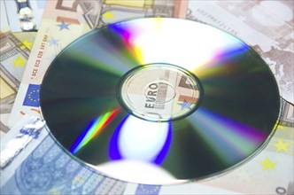 Money euro banknotes and a data cd in close up