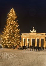 Brandenburg gate in berlin at christmas with snow and people