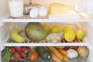 Dairy products, fruits and vegetables in a refrigerator