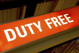 Red illuminated sign with the words duty free
