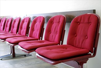 Red seats in a row in a waiting room