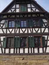 Traditional half-timbered house with green shutters and wooden structure, Kandel, Palatinate,