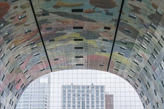 Interior view of a modern market hall with colourful ceiling paintings and glass façade, rotterdam,