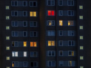 Partially illuminated room windows in a high-rise building at night, Offenbach am Main, Hesse,