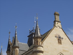 Roof of a historic building with ornate turrets against a clear blue sky, Inverness, Scotland,