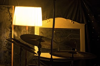 Drums, mirror and lamp, detail of a music rehearsal room