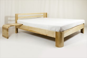 Wooden bed, piece of furniture in front of a white background