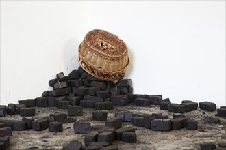 A pile of coal with a coal basket