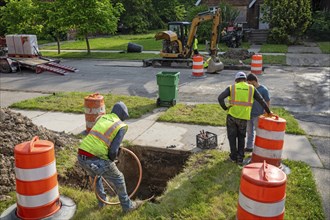 Detroit, Michigan, Workers replace old lead water service lines with copper pipes. Lead is harmful